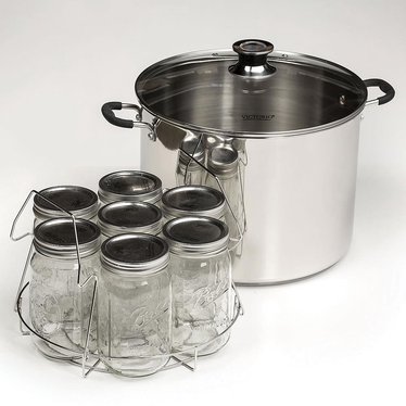 A water bath canner is a simple design of a tall pot, lid with a vent and a canning rack.